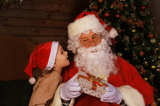 Santa Claus and child at home. Christmas gift. Family holiday concept