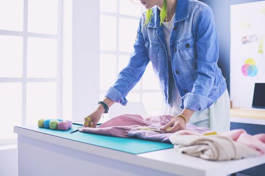 Fashion designer woman working on her designs in the studio.