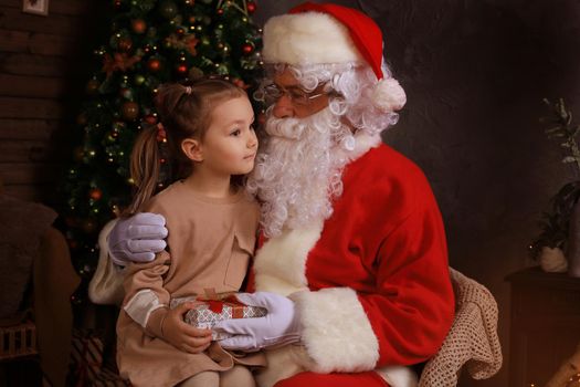 Santa Claus and child at home. Christmas gift. Family holiday concept