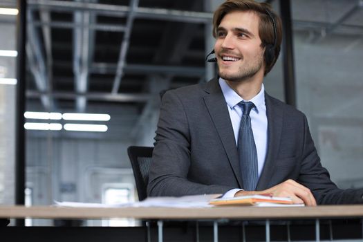 Smiling friendly handsome young male call centre operator