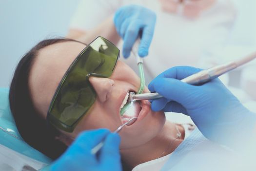 Dental team and patient at dentist's surgery.