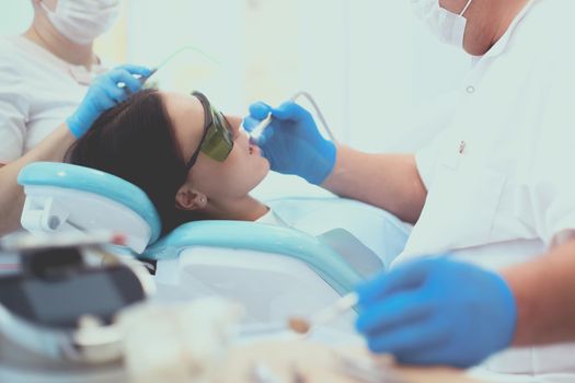 Dentist and his assistant carrying out a thorough examination.