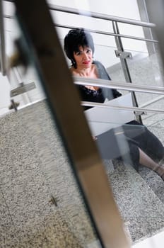 senior business woman work on laptop at modern staircase