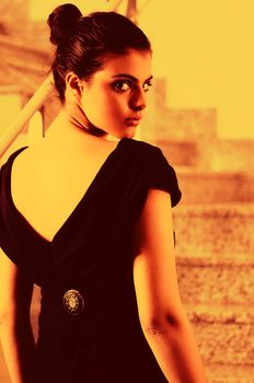 beautiful young lady in black dress shoot from back