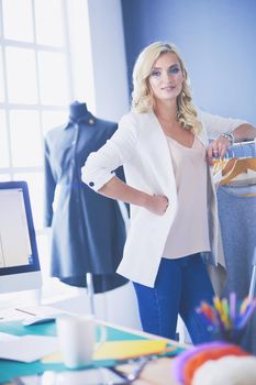 Fashion designer woman working on her designs in the studio
