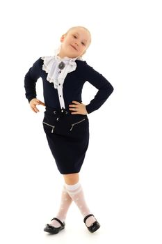 Beautiful little school girl with long silky hair. Studio portrait in full growth. Concept of style and fashion, happy people. Isolated on white background.