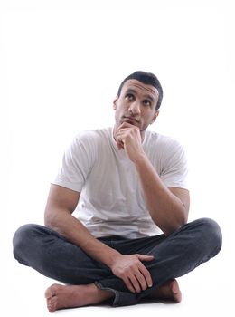 portrait of relaxed young man dressed in white shirt and jeans isolated over white background in studio