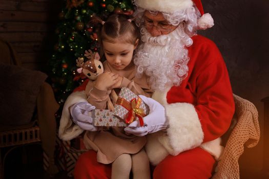 Santa Claus and child at home. Christmas gift. Family holiday concept