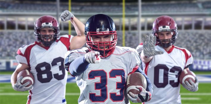 Portrait of American football player pointing against gray background