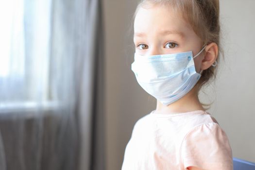 Little european girl wearing mask for protect Covid-19