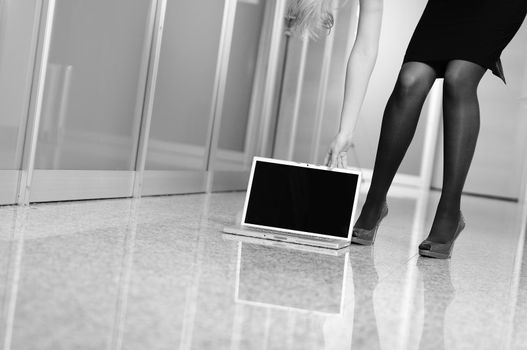 business woman stand with shoe on modern laptop