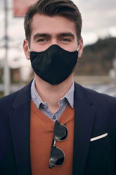 corporate businessman wearing protective medical face mask at modern open space office concept of new normal in business