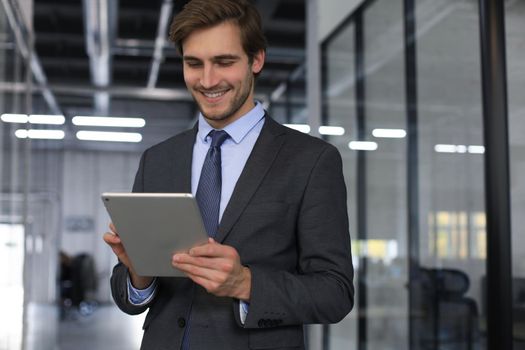 Young man using his tablet in the office.