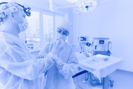 Man surgeon at work in operating room.