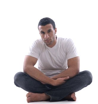 portrait of relaxed young man dressed in white shirt and jeans isolated over white background in studio