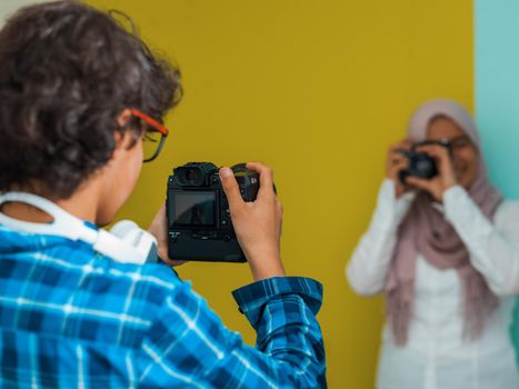 a photo of a young Arab teenager having fun with a camera. Selective focus. High quality photo