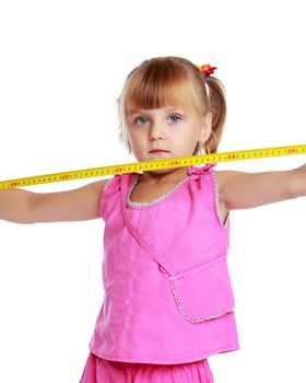 Cute little girl playing with a building tape. The concept of construction, advertising. Isolated on white background.