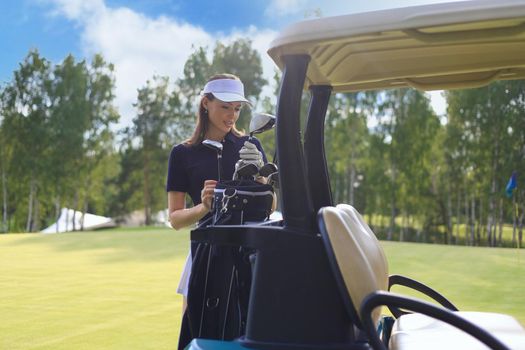 Beautiful cheerful woman standing near in golf cart