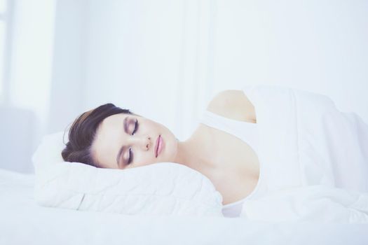 Young beautiful woman lying in bed