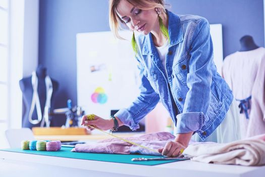 Fashion designer woman working on her designs in the studio.