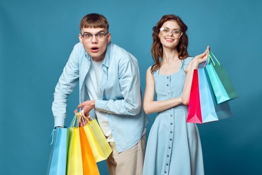 young couple with shopping bags fashion studio. High quality photo