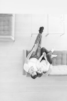 top view of Young couple on the sofa watching television together at home