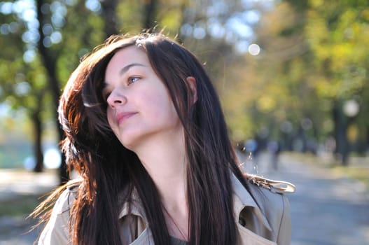 Cute young woman smiling outdoors in nature