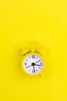 A yellow alarm clock on a yellow background is a copy device. An article about time. An article about an alarm clock.