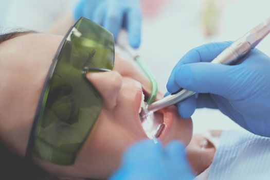 Dental team and patient at dentist's surgery.