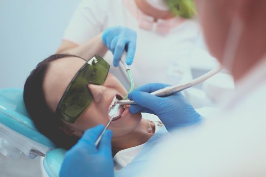 Dental team and patient at dentist's surgery.