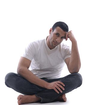 portrait of relaxed young man dressed in white shirt and jeans isolated over white background in studio