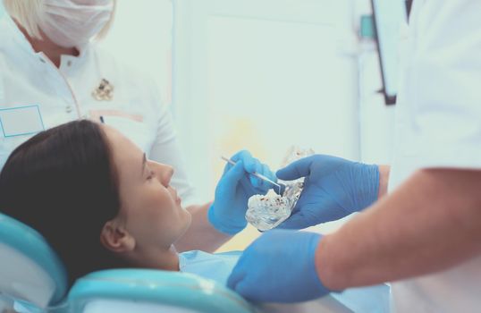 Dentist and his assistant carrying out a thorough examination.