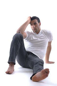 portrait of relaxed young man dressed in white shirt and jeans isolated over white background in studio