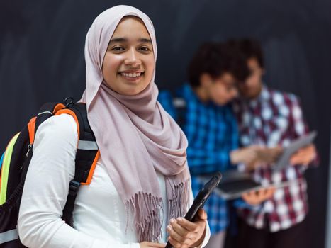 Modern Arab teens use smartphones, tablets, and laptops to study during online classes due to corona virus pandemic. High quality photo