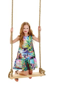 Beautiful little girl swinging on a swing. The concept of family happiness, summer holidays. Isolated on white background.