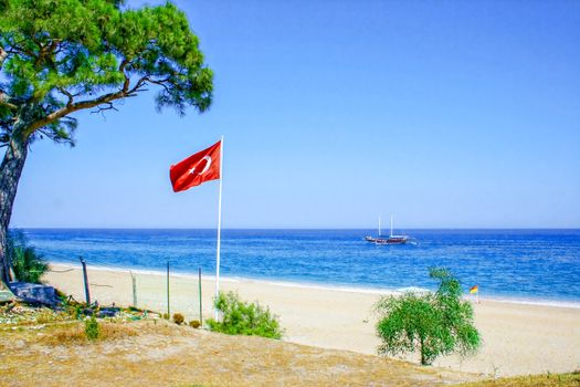 Turkey flag on the background of the sea and blue sky. In the summer while relaxing at sea.