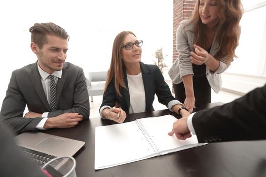 Businesswoman standing and leading business presentation.