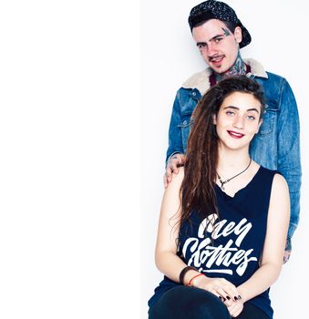 Young couple together. guy with tattoo, girlfriend wearing dreadlocks having fun on white background close up