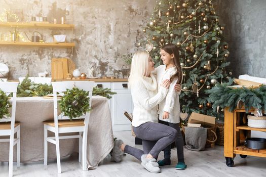 Mother and daughter in front of Christmas tree