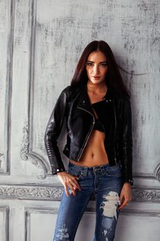 young brunette woman in leather jacket at vintage wall, lifestyle people concept close up