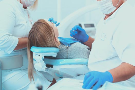 Dentist and his assistant carrying out a thorough examination.