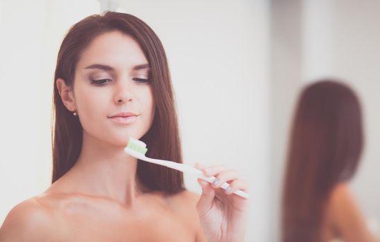 Portrait of a young girl cleaning her teeth.