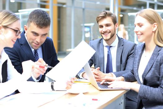 Group of business partners discussing ideas and planning work in office