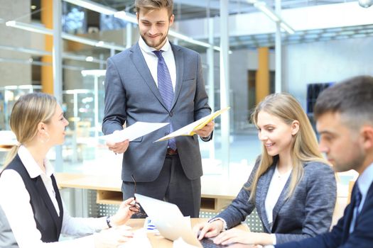 Image of business partners discussing documents and ideas at meeting