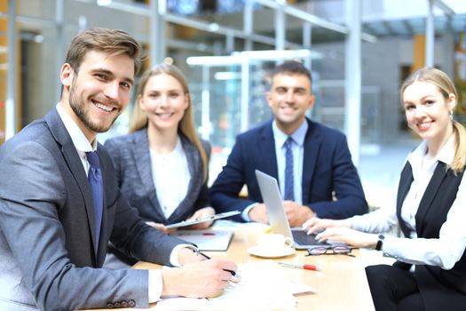 Businessman with colleagues in the background in office