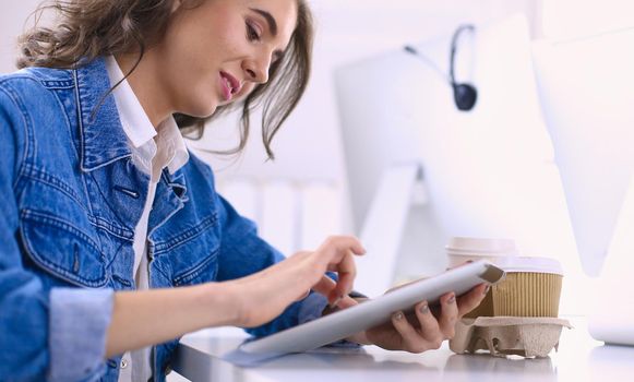 Young woman using digital tablet at office