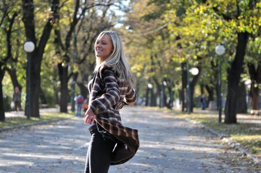 Cute young woman smiling outdoors in nature