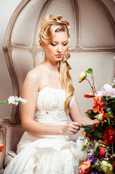 beauty young bride alone in luxury vintage interior with a lot of flowers, makeup and creative hairstyle close up