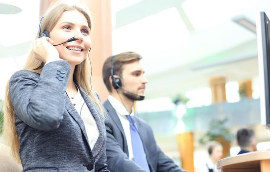 Female customer support operator with headset and smiling