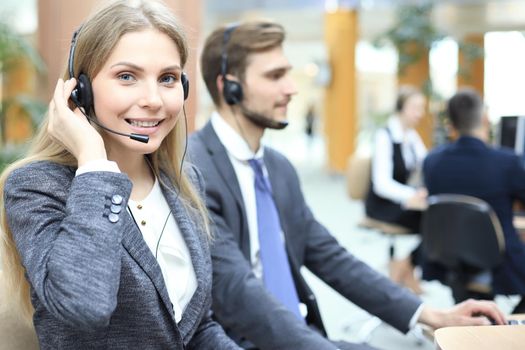 Female customer support operator with headset and smiling